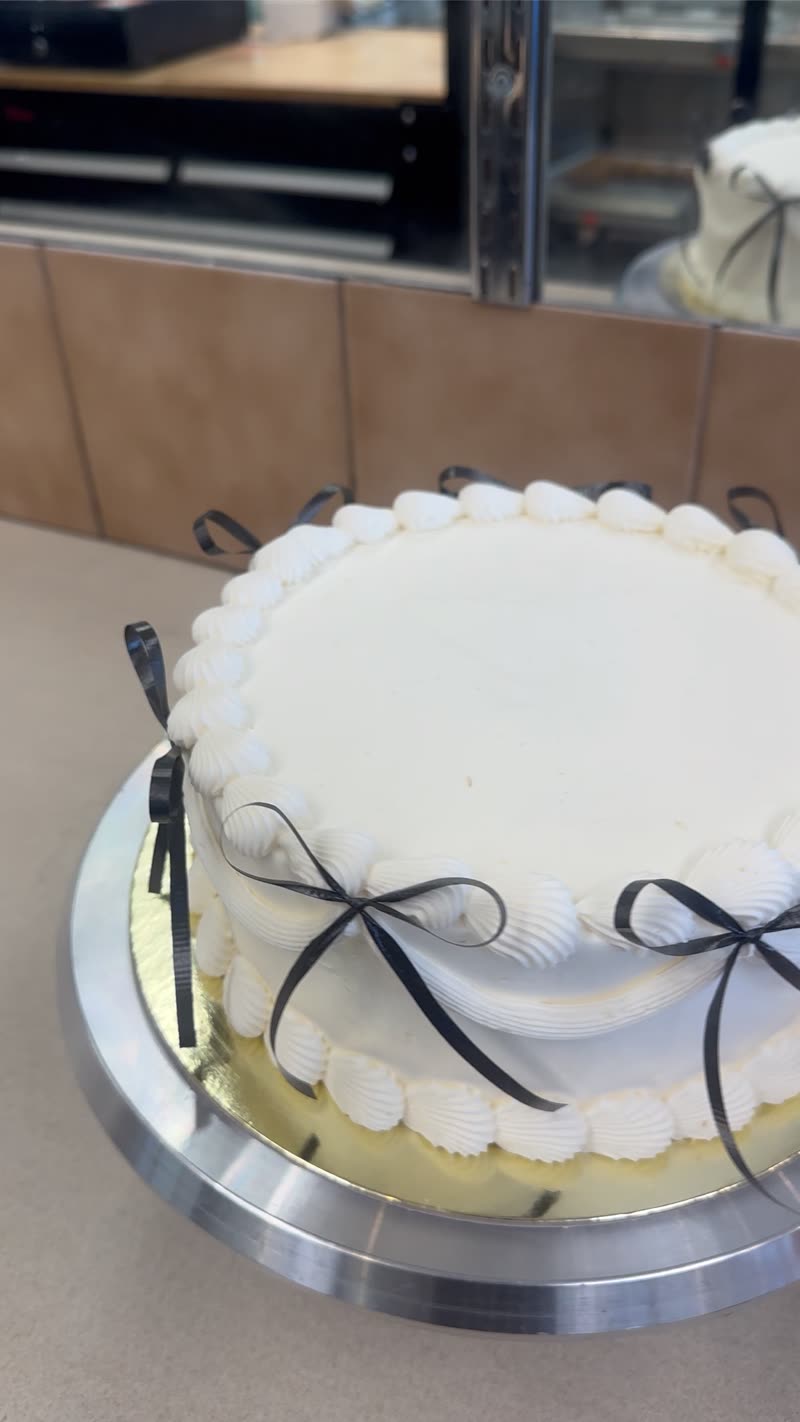 White cake with black ribbon bows