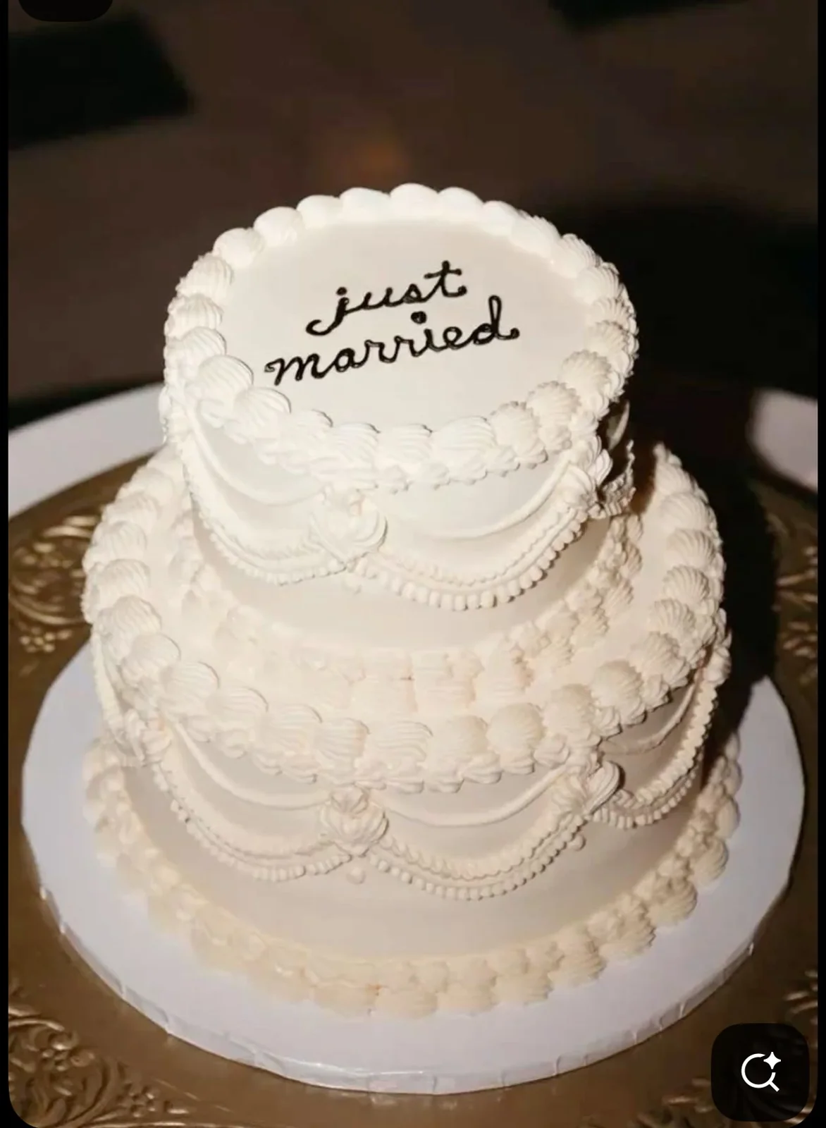 White two-tier piped wedding cake with Just Married message