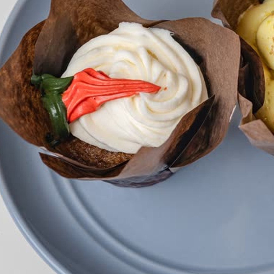 Carrot cupcake with cream cheese frosting and piped carrot