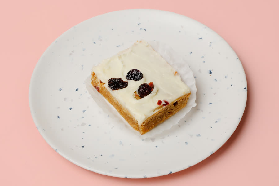 Ginger blondie with cream cheese icing and cranberries