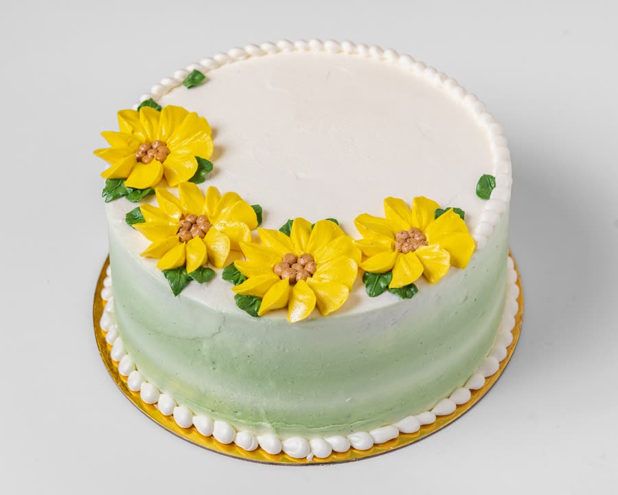 Vanilla buttercream cake with piped sunflowers
